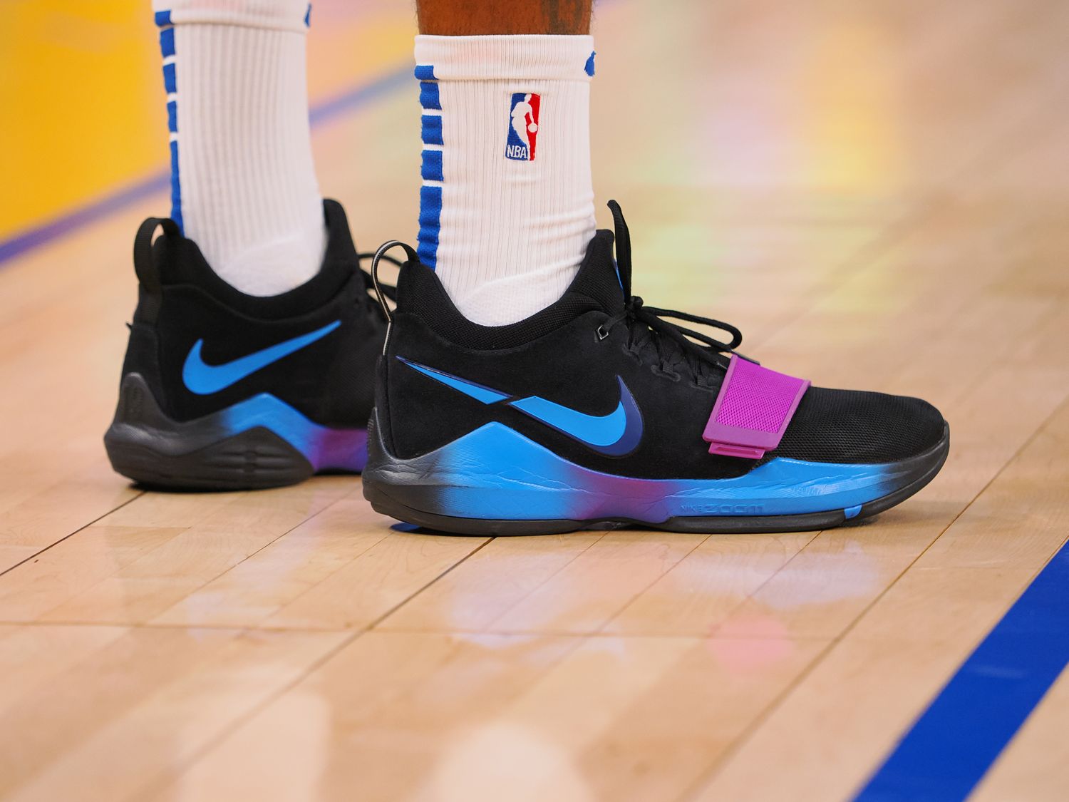 Los Angeles Clippers forward Paul George's black and blue Nike sneakers.
